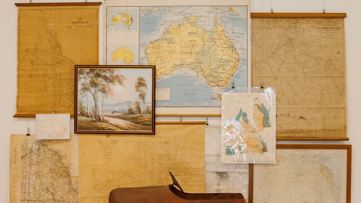 Historic maps, a painting, and a toy car.