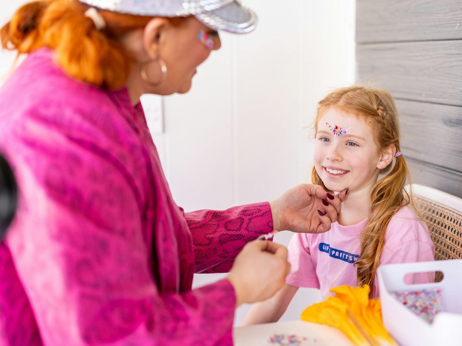 Young girl getting bedazzled at the Glam Bar