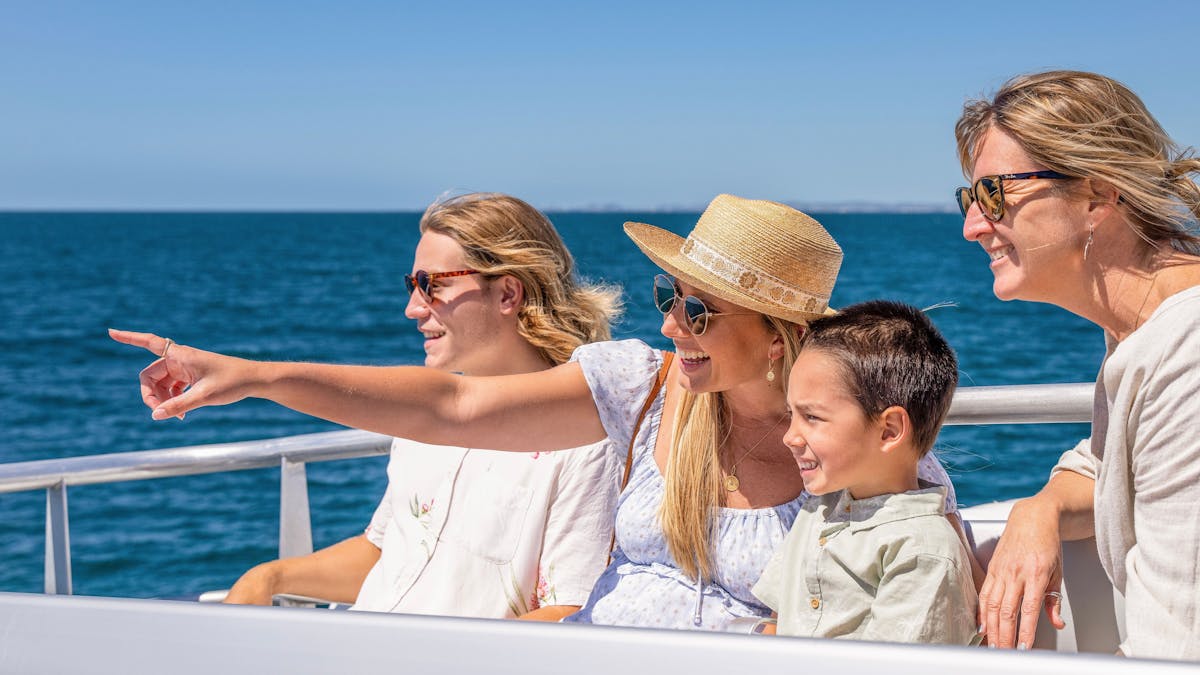 Family pointing at whale
