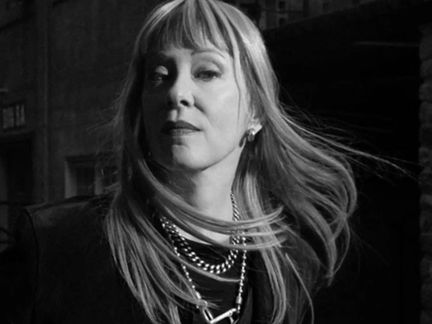 black and white image with Suzanne with long flowing hair with fringe