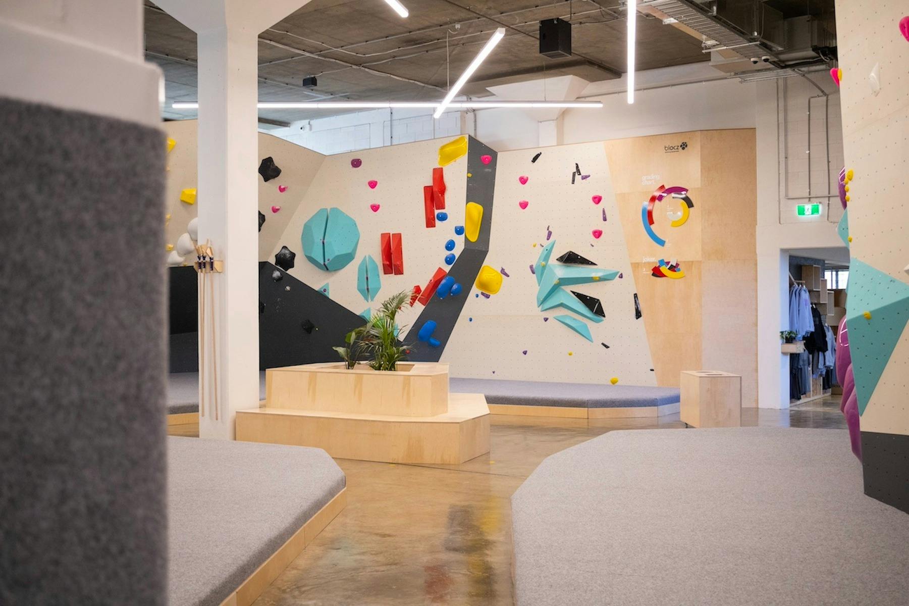 a wide, landscape video of a colourful climbing gym