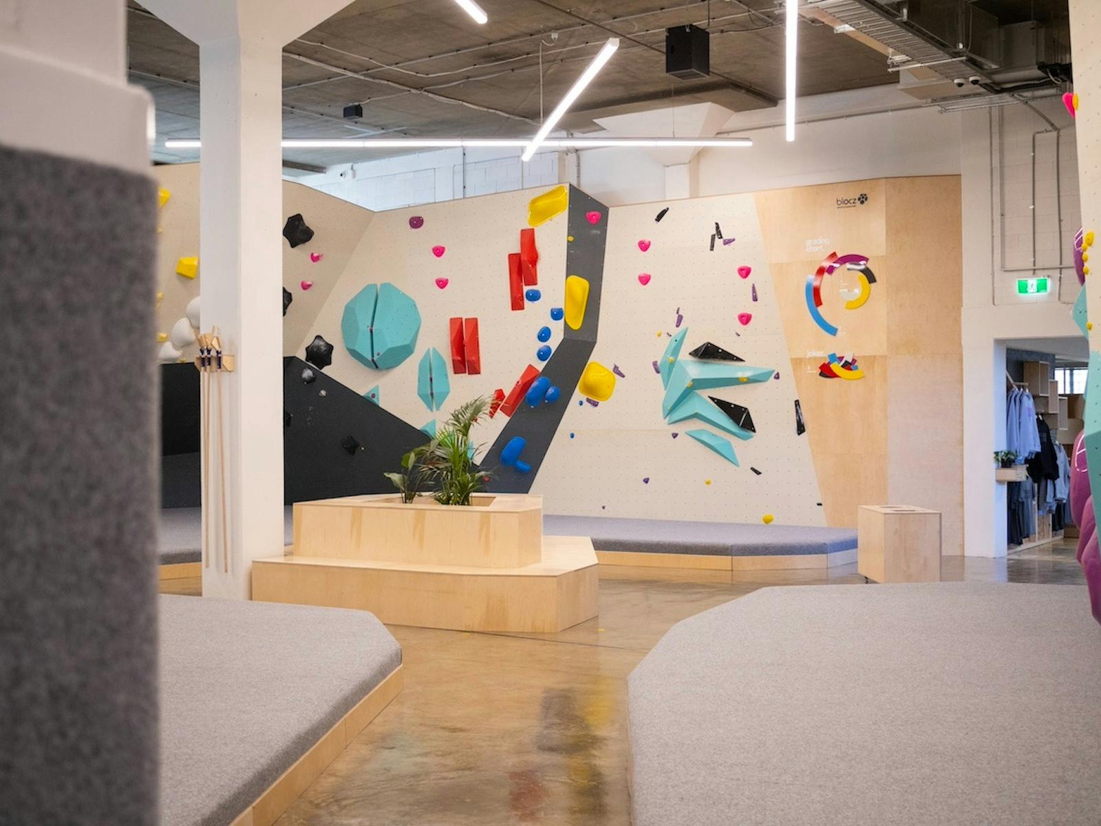 a wide, landscape video of a colourful climbing gym