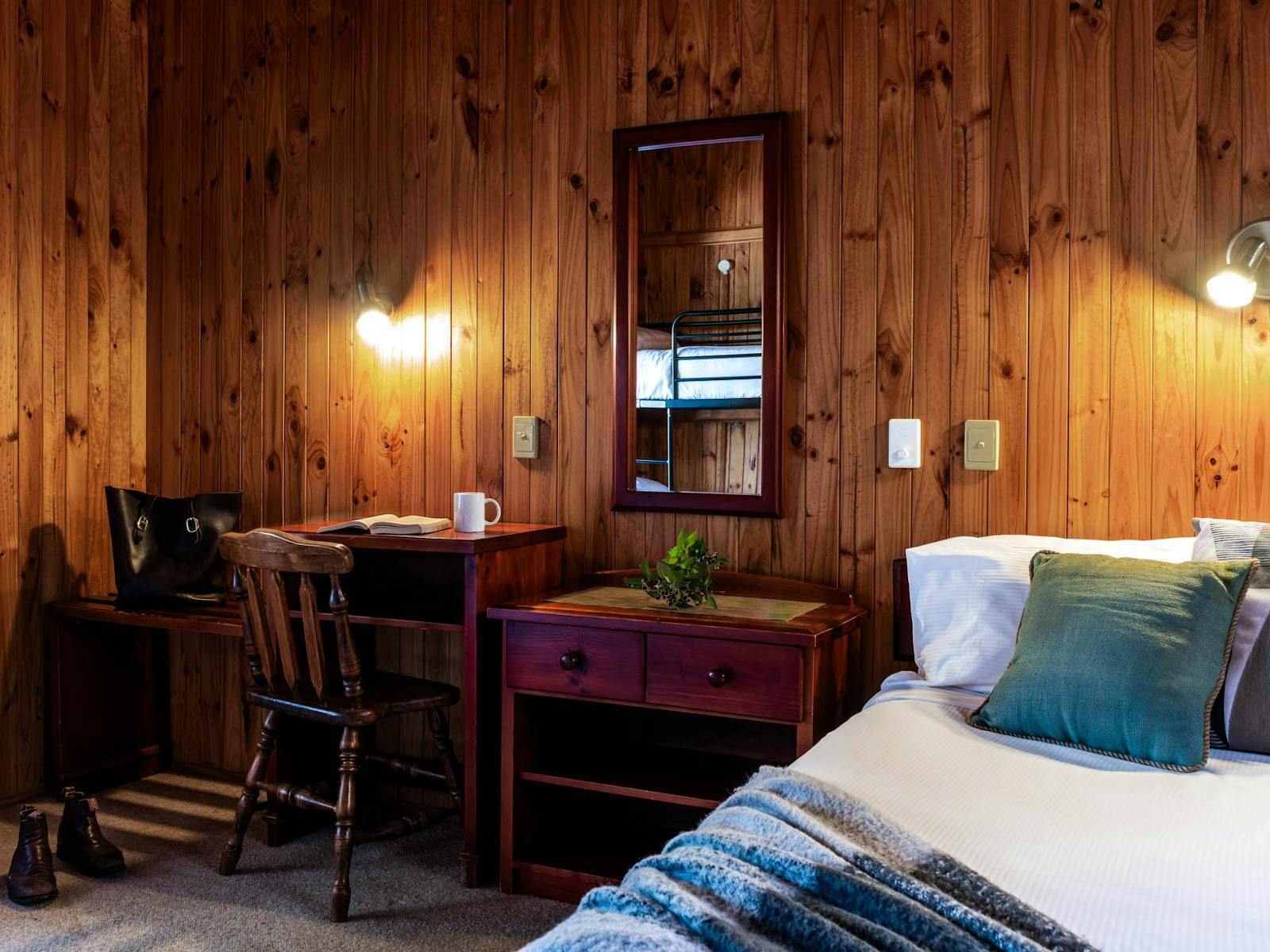 Timber bedroom with wooden furniture and freshly made beds Timber bedroom with wooden furniture and freshly made beds