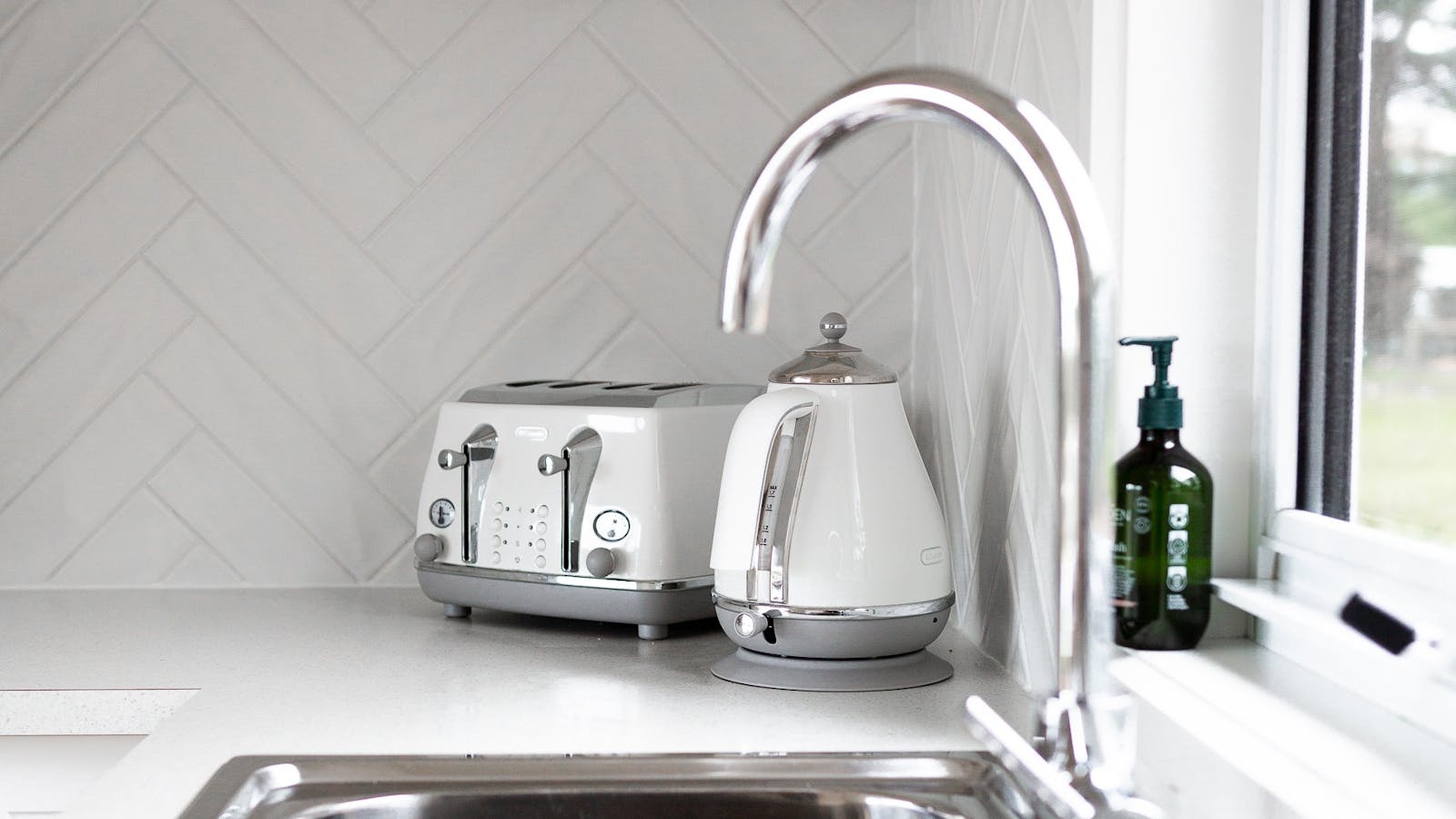 Quality kitchen appliances oven stovetop, dishwasher coffee machine provided