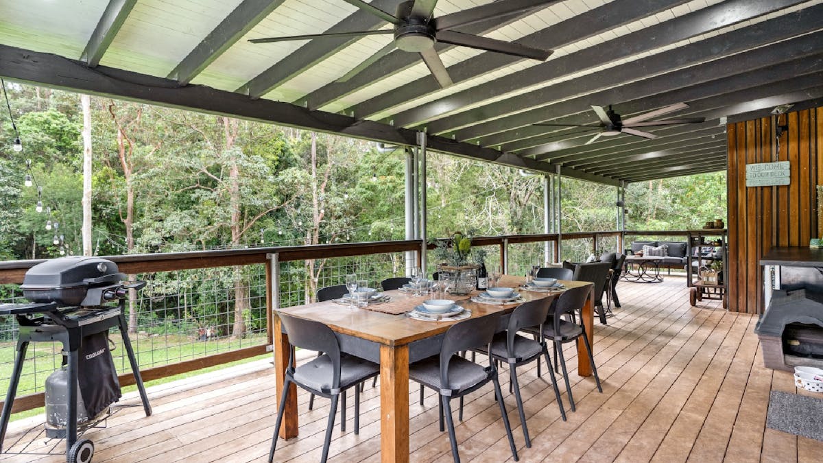 Balcony with outdoor dining and sitting areas