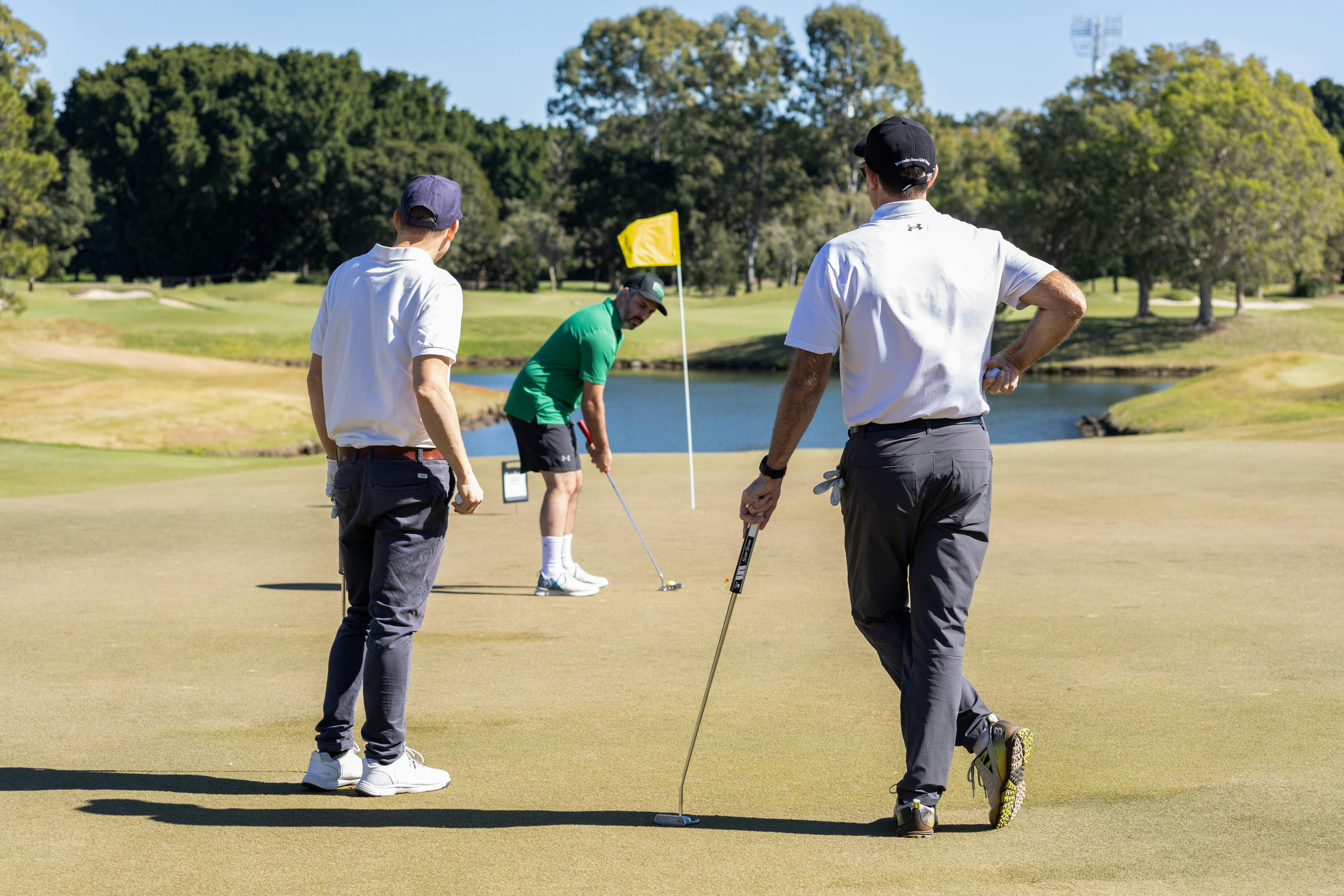 Golfers putting on the green during the annual Storyfest Charity Golf Day.