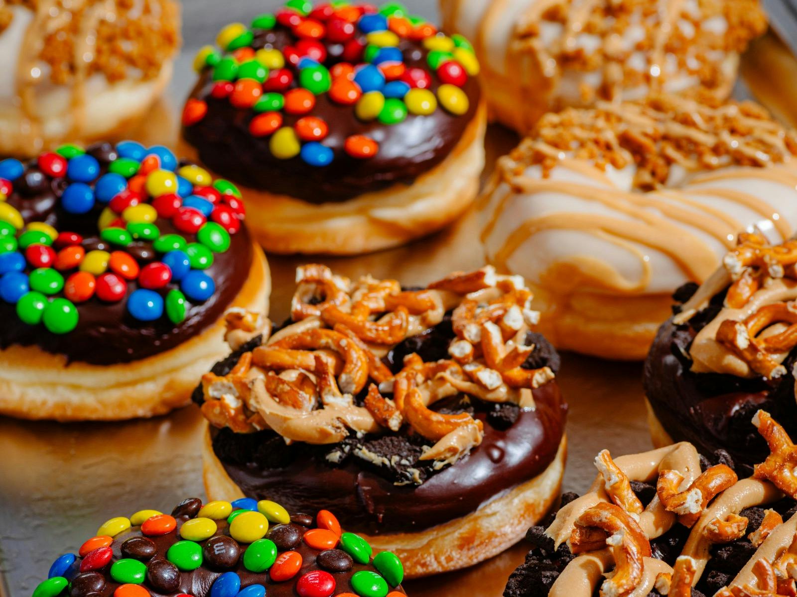 A group of artisan doughnuts of various flavours.
