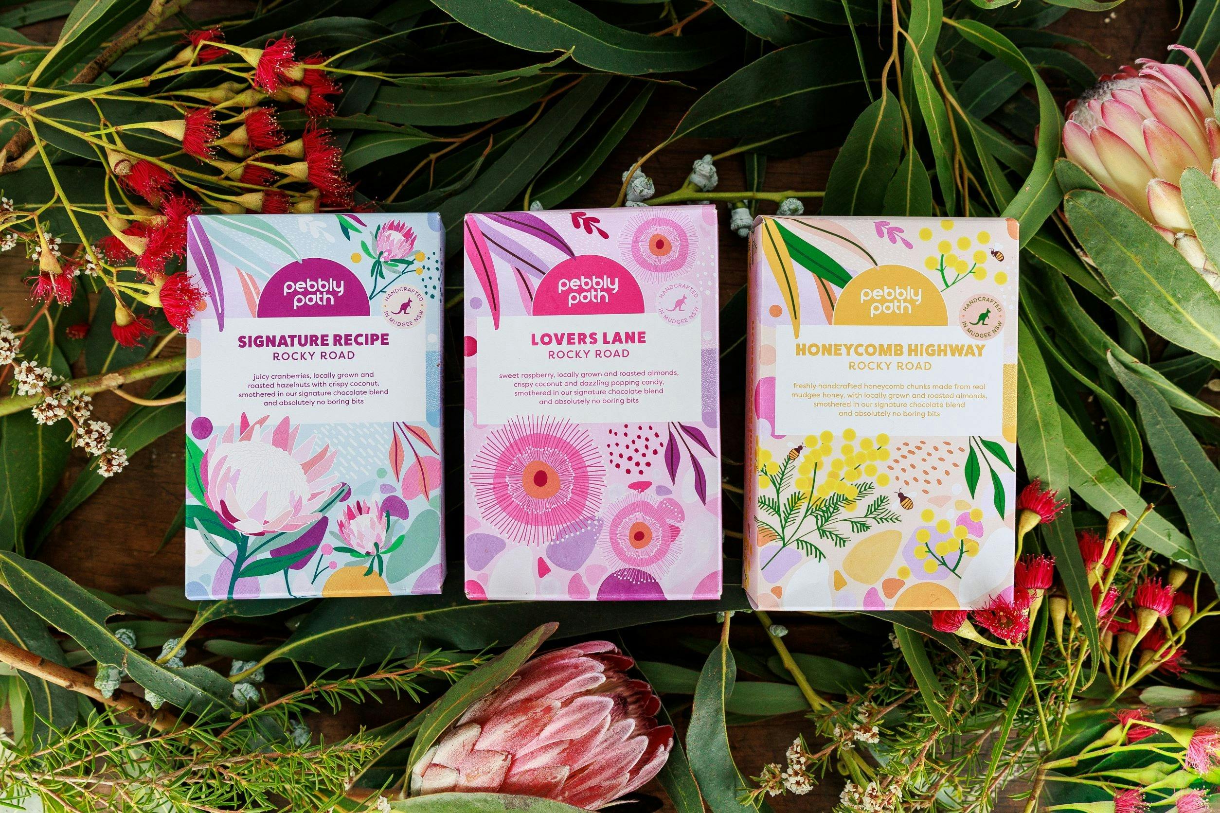 rocky road boxes in three colourways on a bed of native flowers