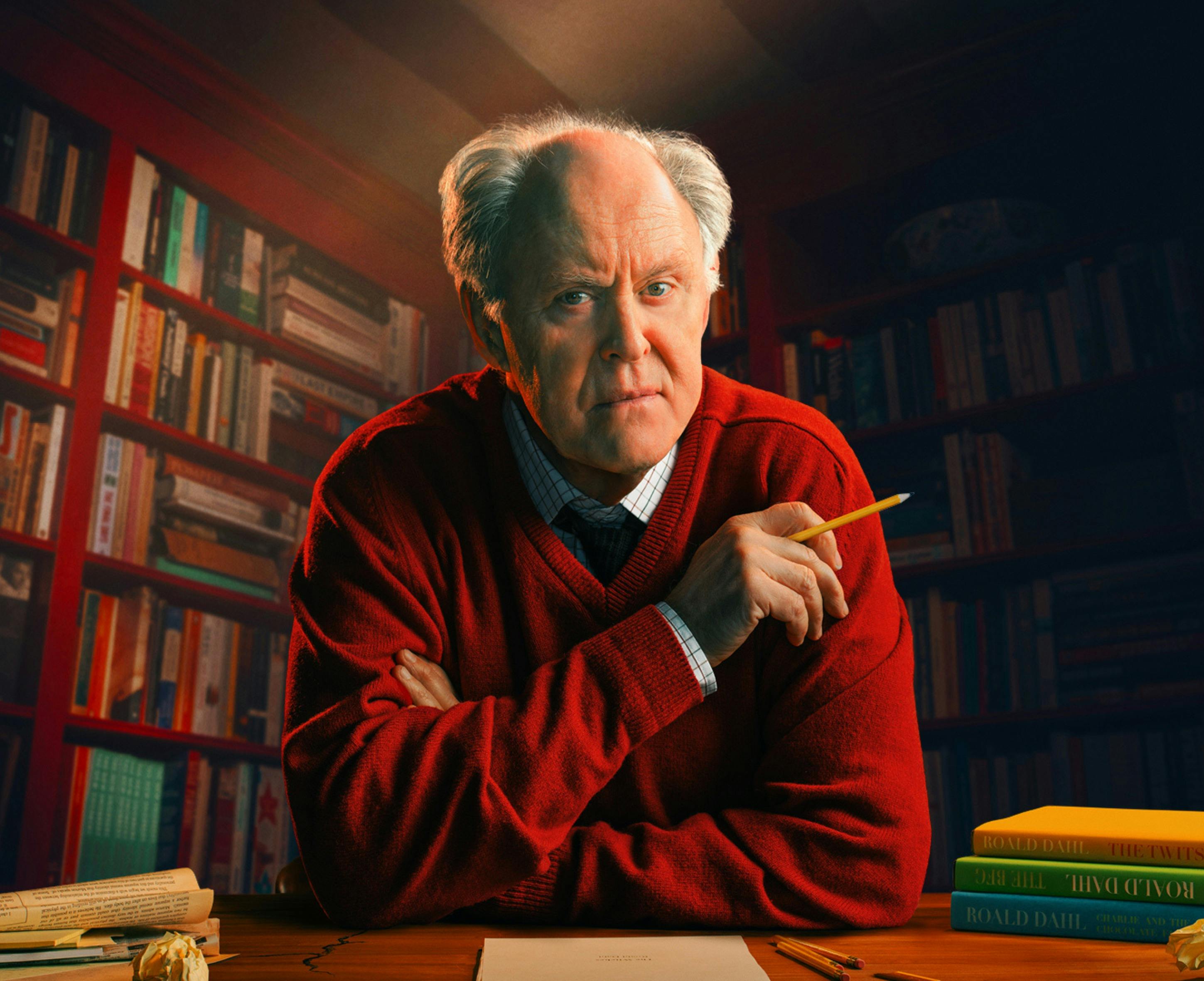 John Lithgow poses in a library