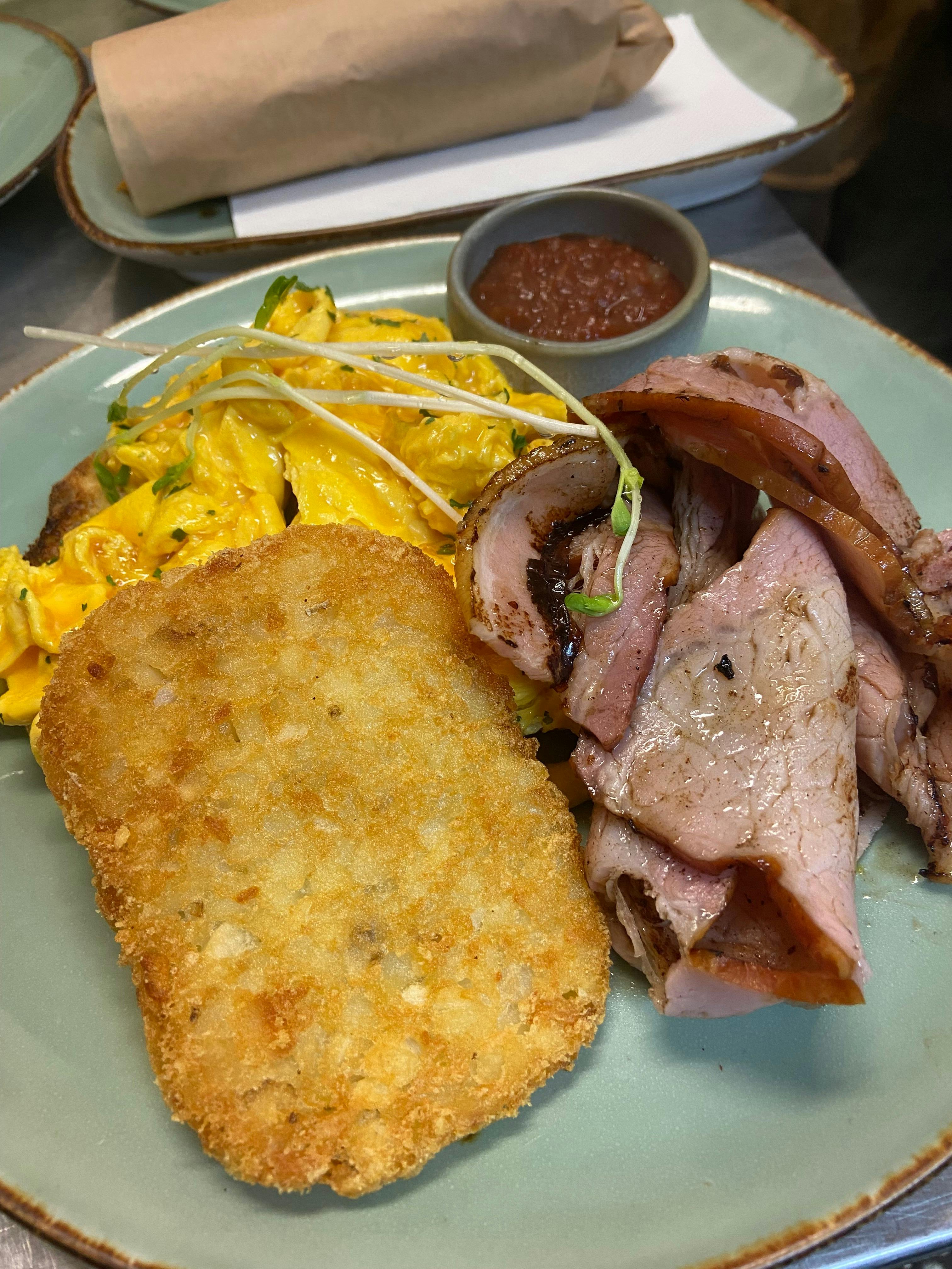 A plate of cooked breakfast including eggs and bacon