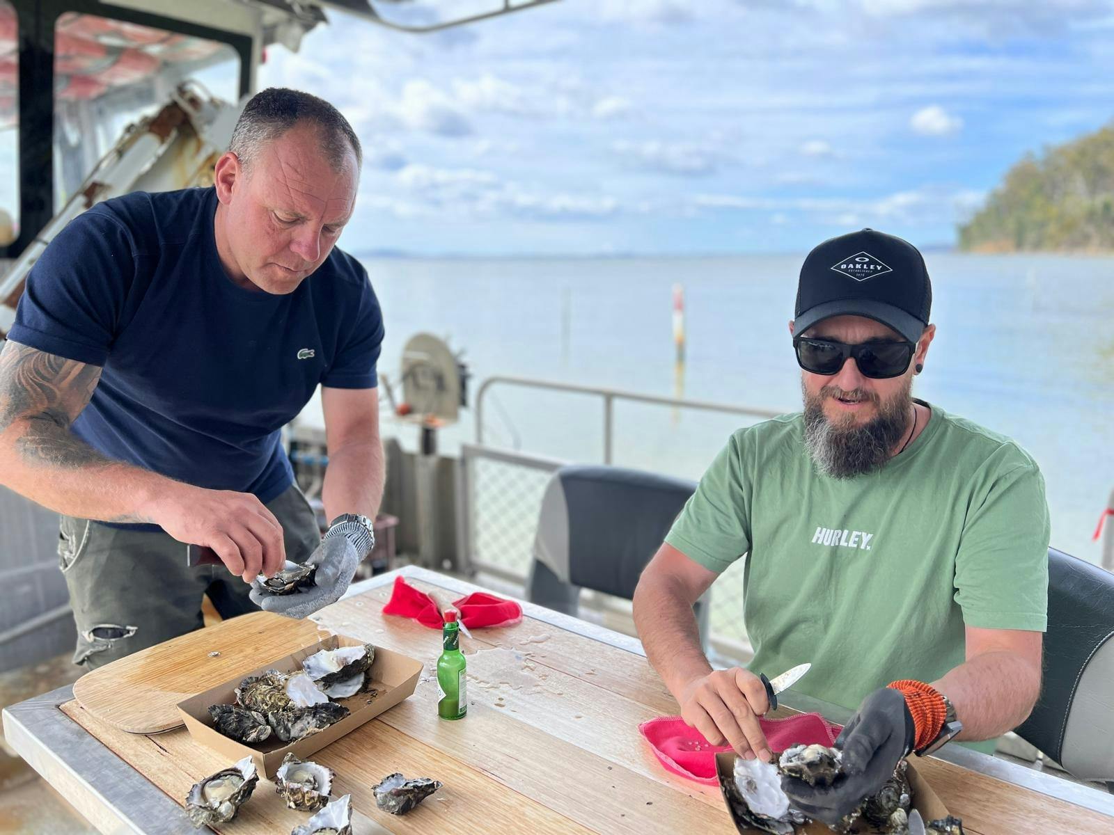 The oyster farmer showing how to shuck oysters