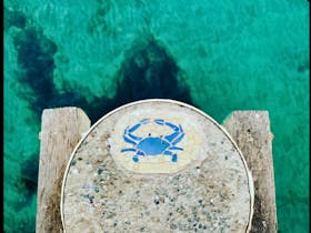 Blue crab mosaic on the Port Neill Jetty overlooking crystal-clear turquoise water Eyre Peninsula