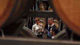 Guests enjoy a behind the scenes tour in the old barrel hall at Wirra Wirra.