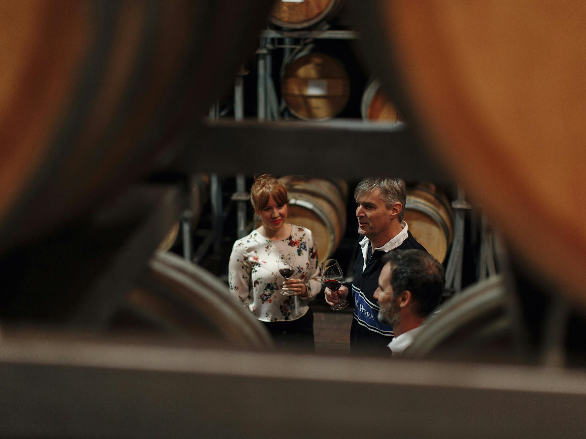 Guests enjoy a behind the scenes tour in the old barrel hall at Wirra Wirra.