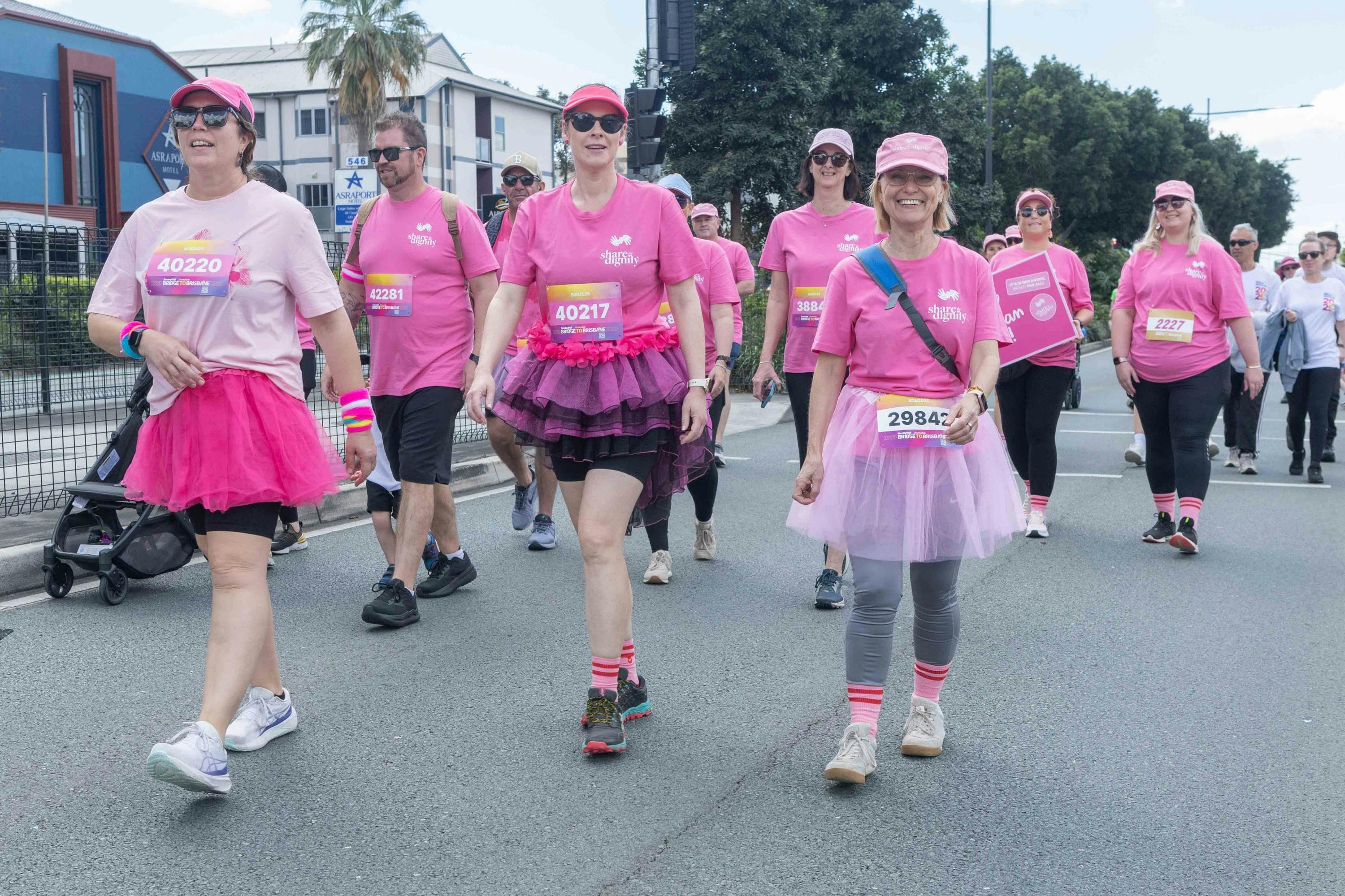 Group of people dressed in pink shirts for the Share the Dignity charity walking.