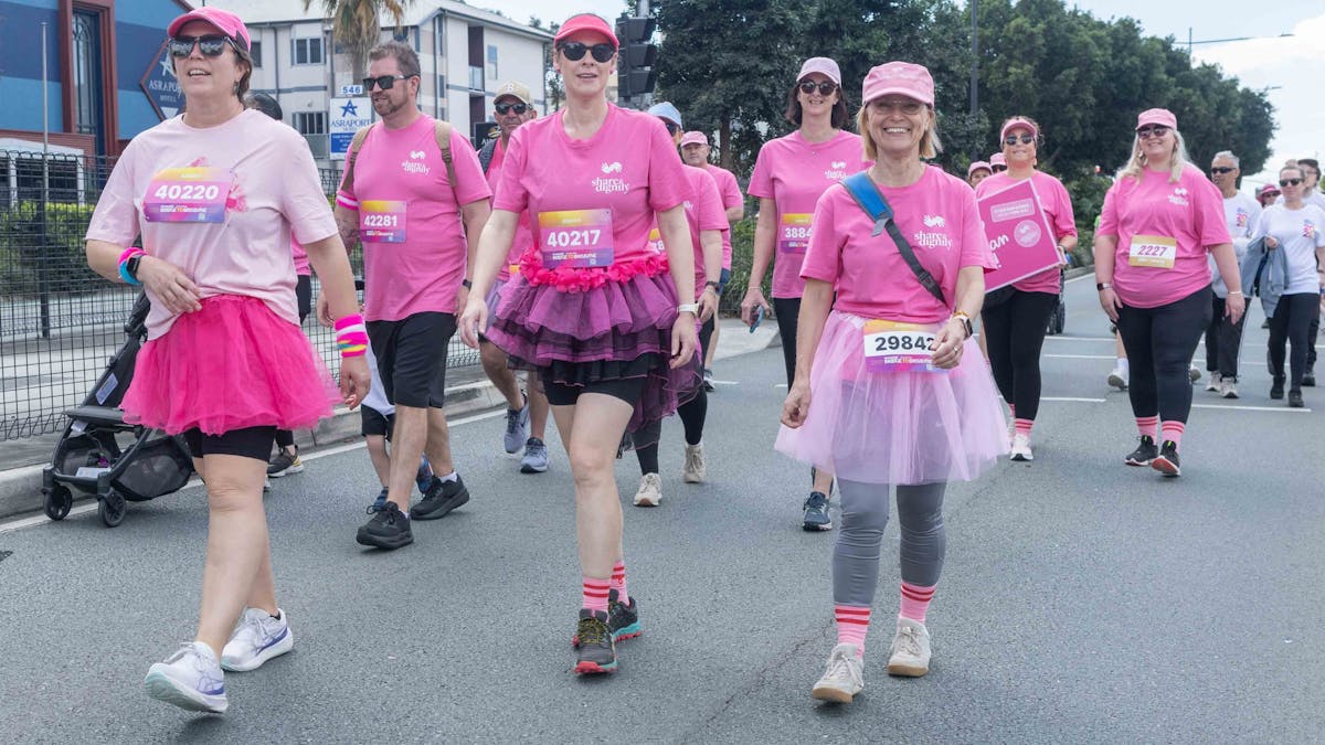Group of people dressed in pink shirts for the Share the Dignity charity walking.