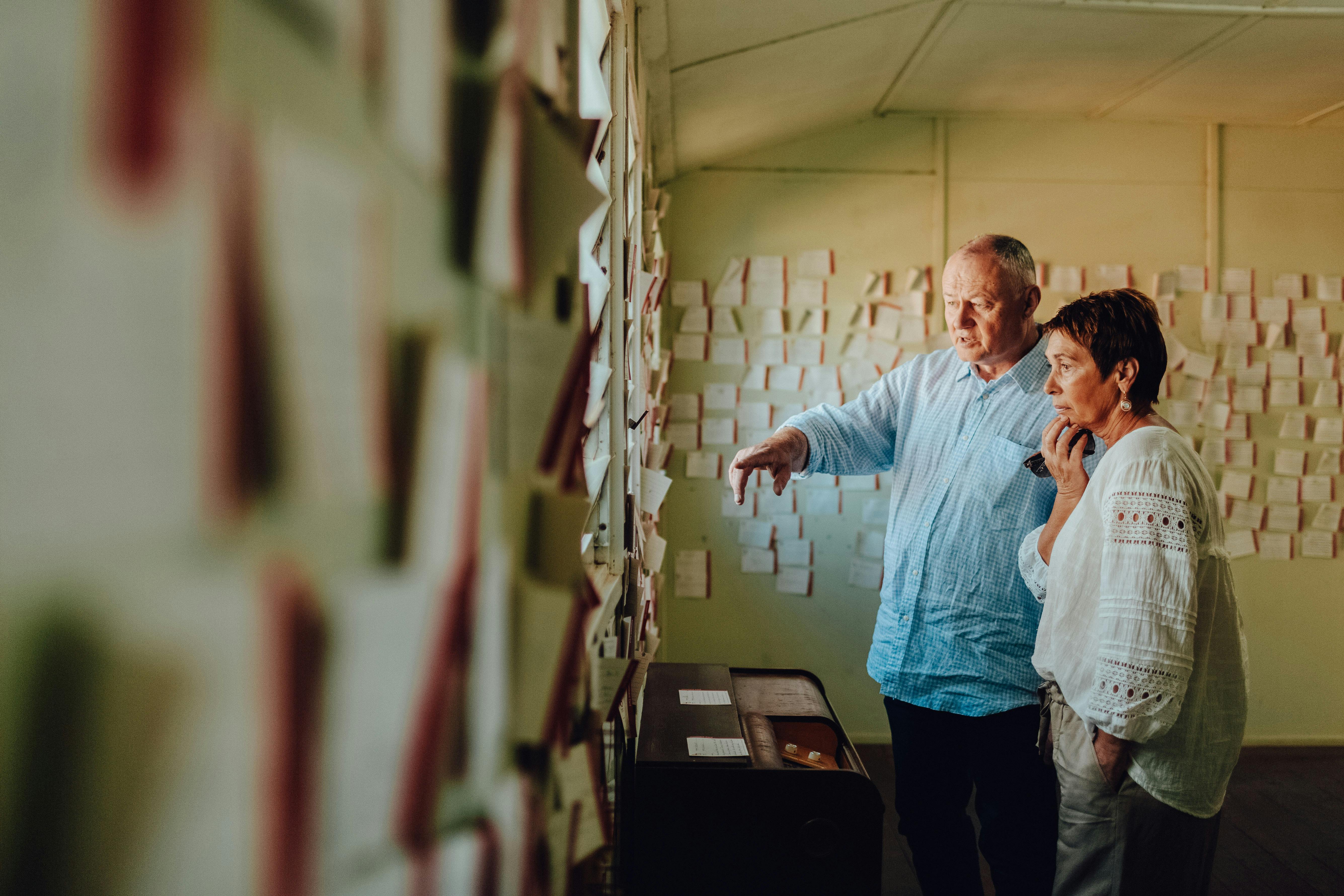 two people looking at notes on the wall at the Bonegilla Migrant Experience
