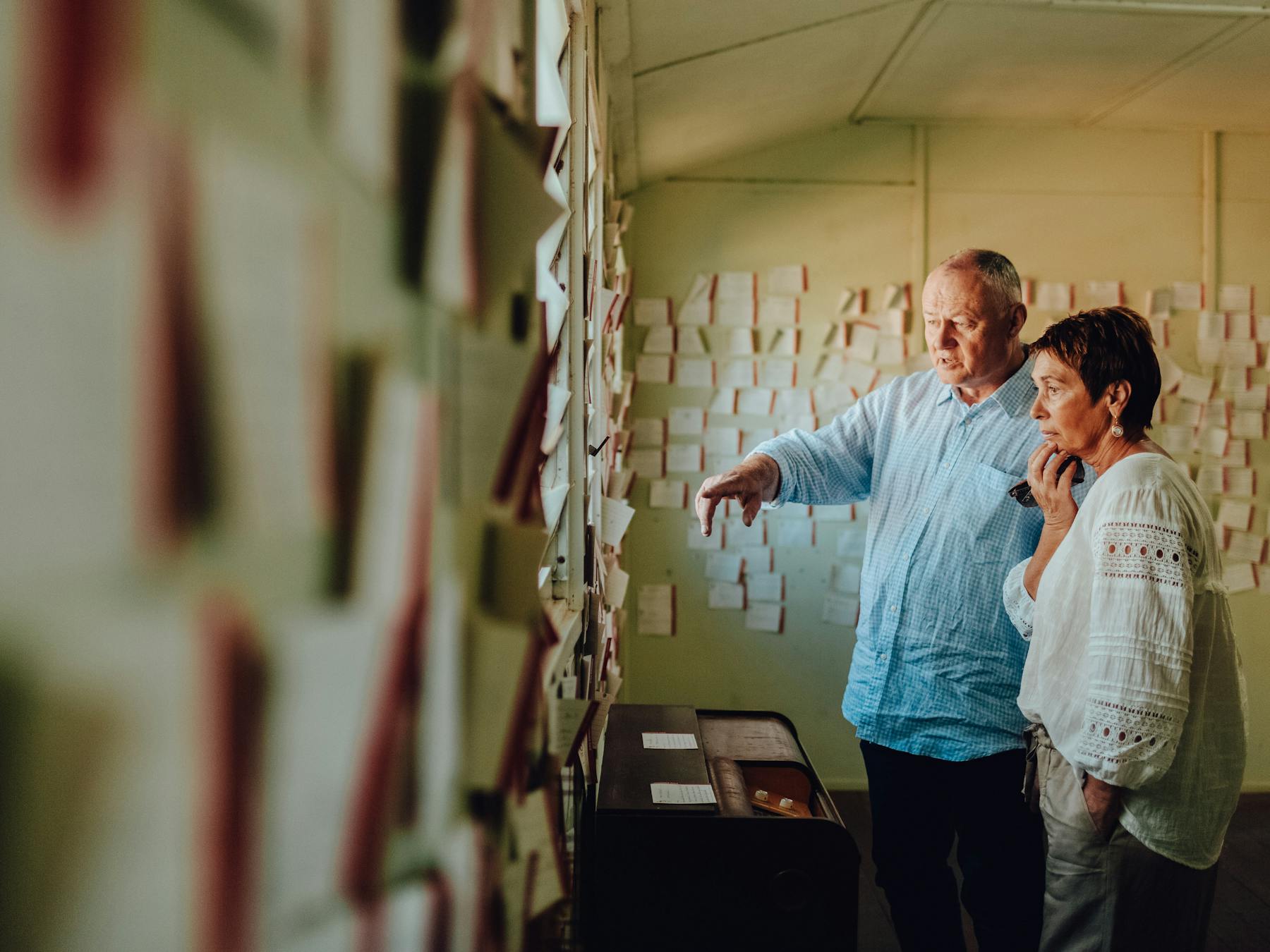 two people looking at notes on the wall at the Bonegilla Migrant Experience