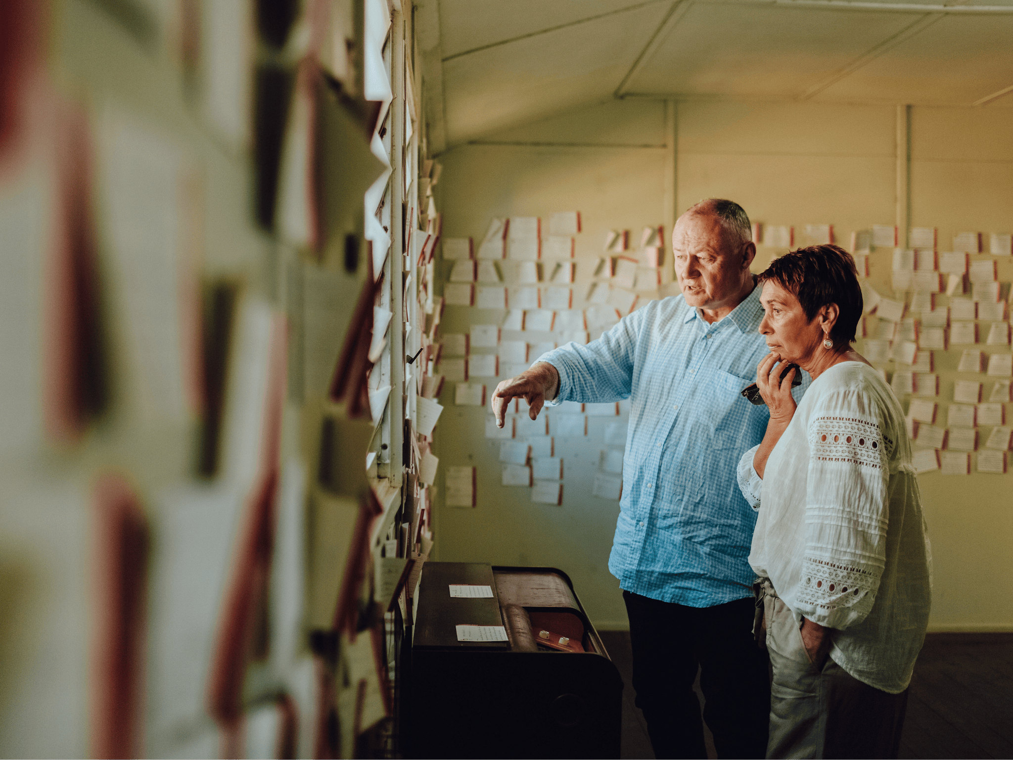 two people looking at notes on the wall at the Bonegilla Migrant Experience