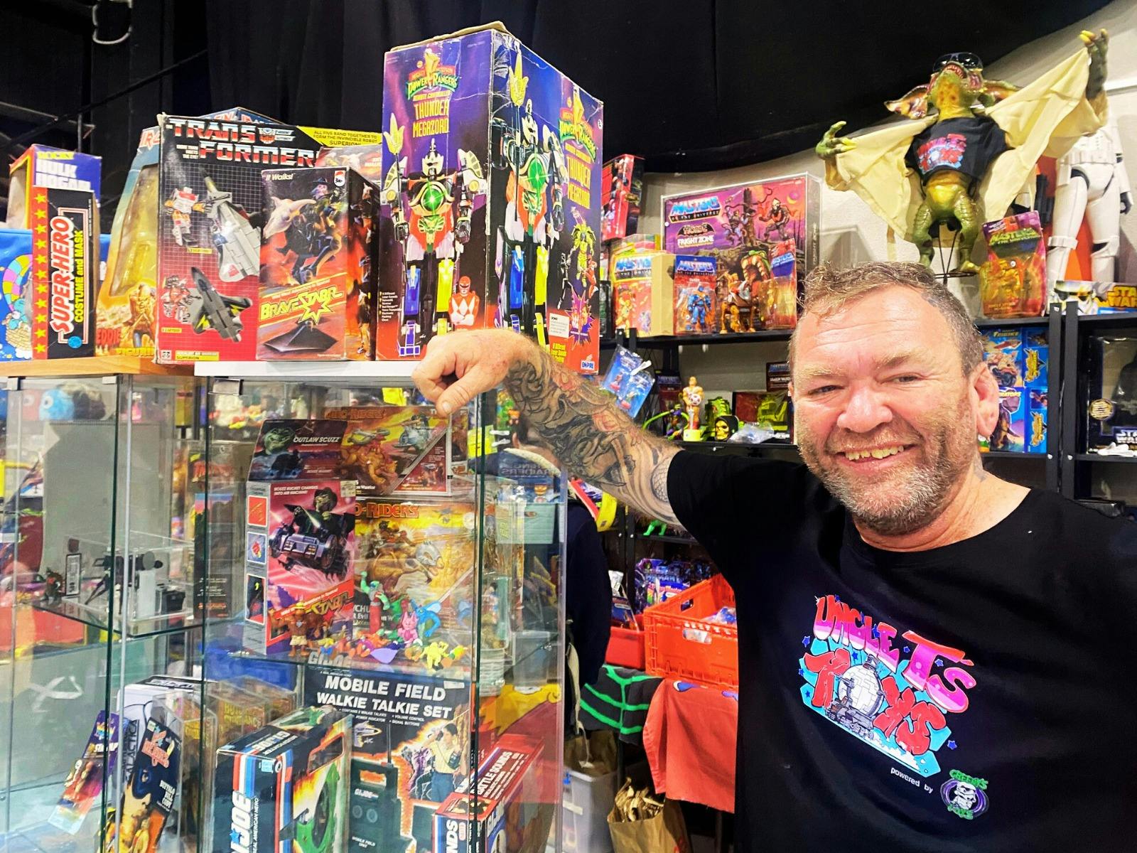 Vendor 'Uncle T' in front of his stall with vintage toys
