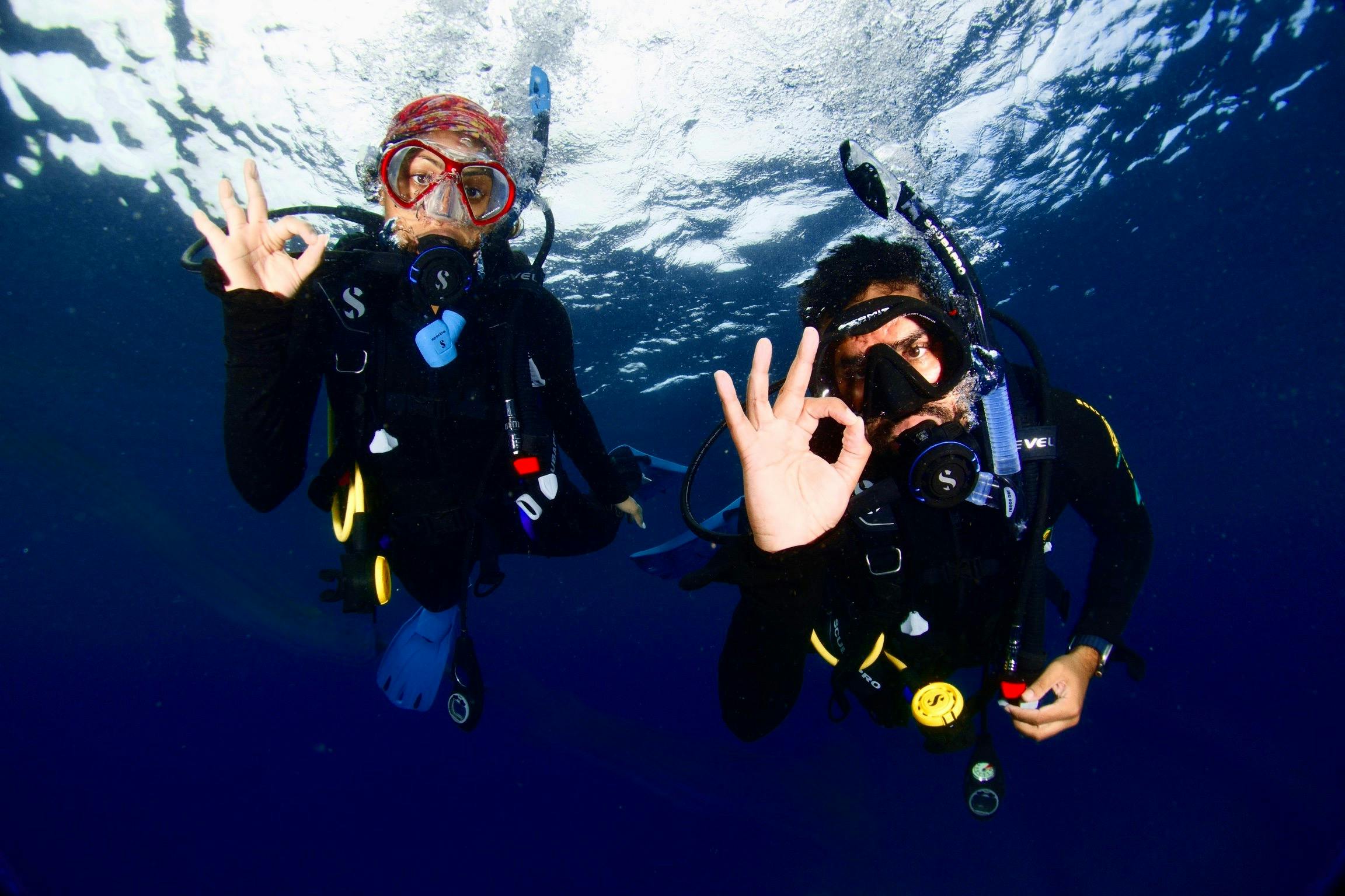 Scuba Diver signalling ok to their private guide photographer