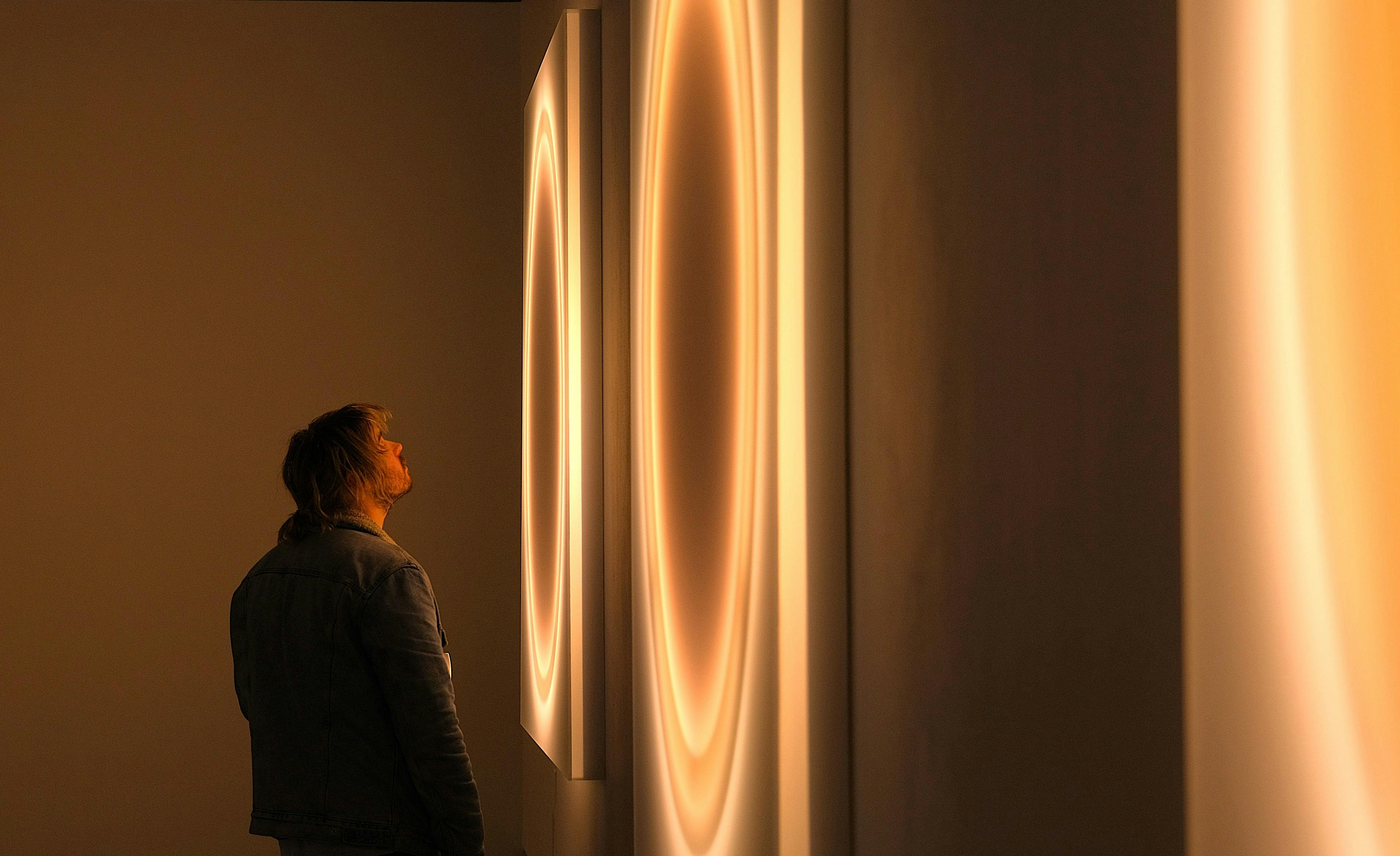 Visitor viewing new neon works by Cobi Cockburn at Canberra Glassworks