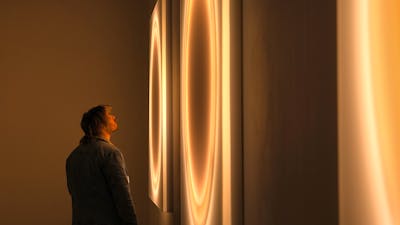 Visitor viewing new neon works by Cobi Cockburn at Canberra Glassworks
