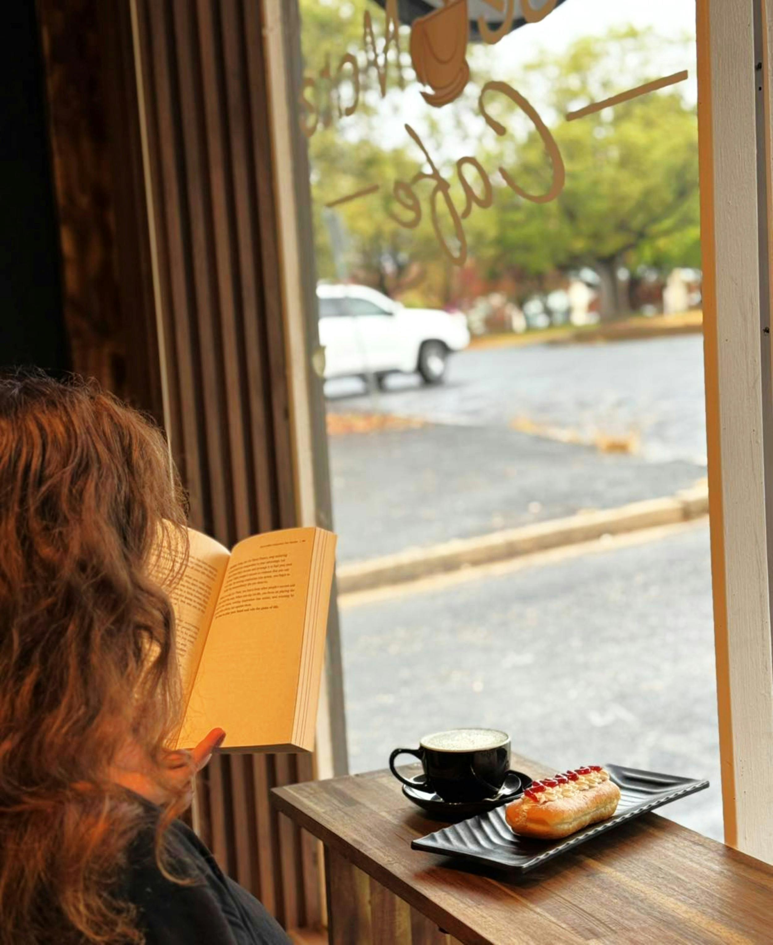 Reading with a coffee by the window