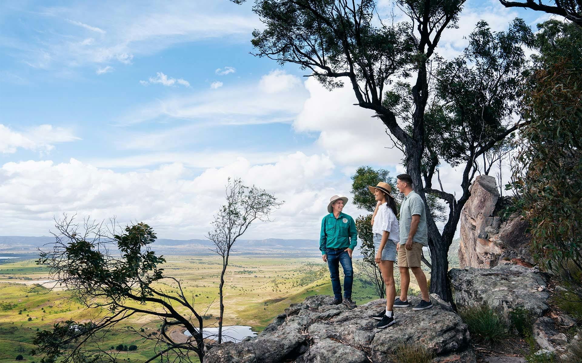 A Boobook Explore guide and two guests standing at an overlook of Arcadia Valley, QLD