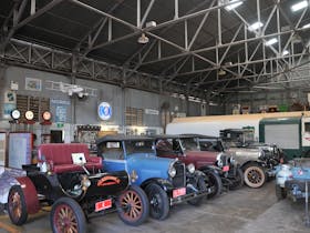 Interior of the Hangar showing the roof trusses and framing. The display is by the Automobile Enthusiasts Club.
