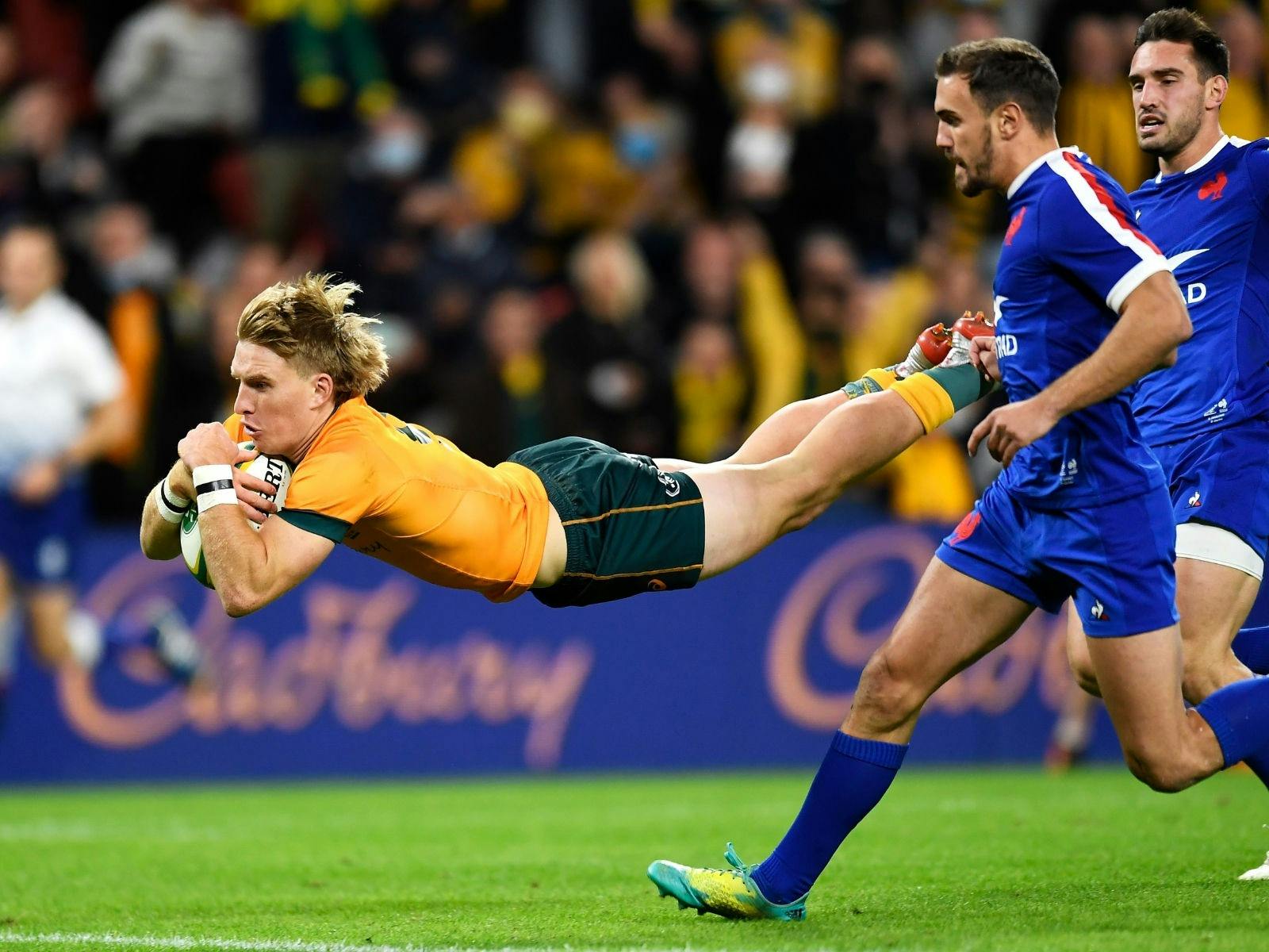 Tate McDermott diving with the ball for the Wallabies Tate McDermott diving with the ball for the Wallabies