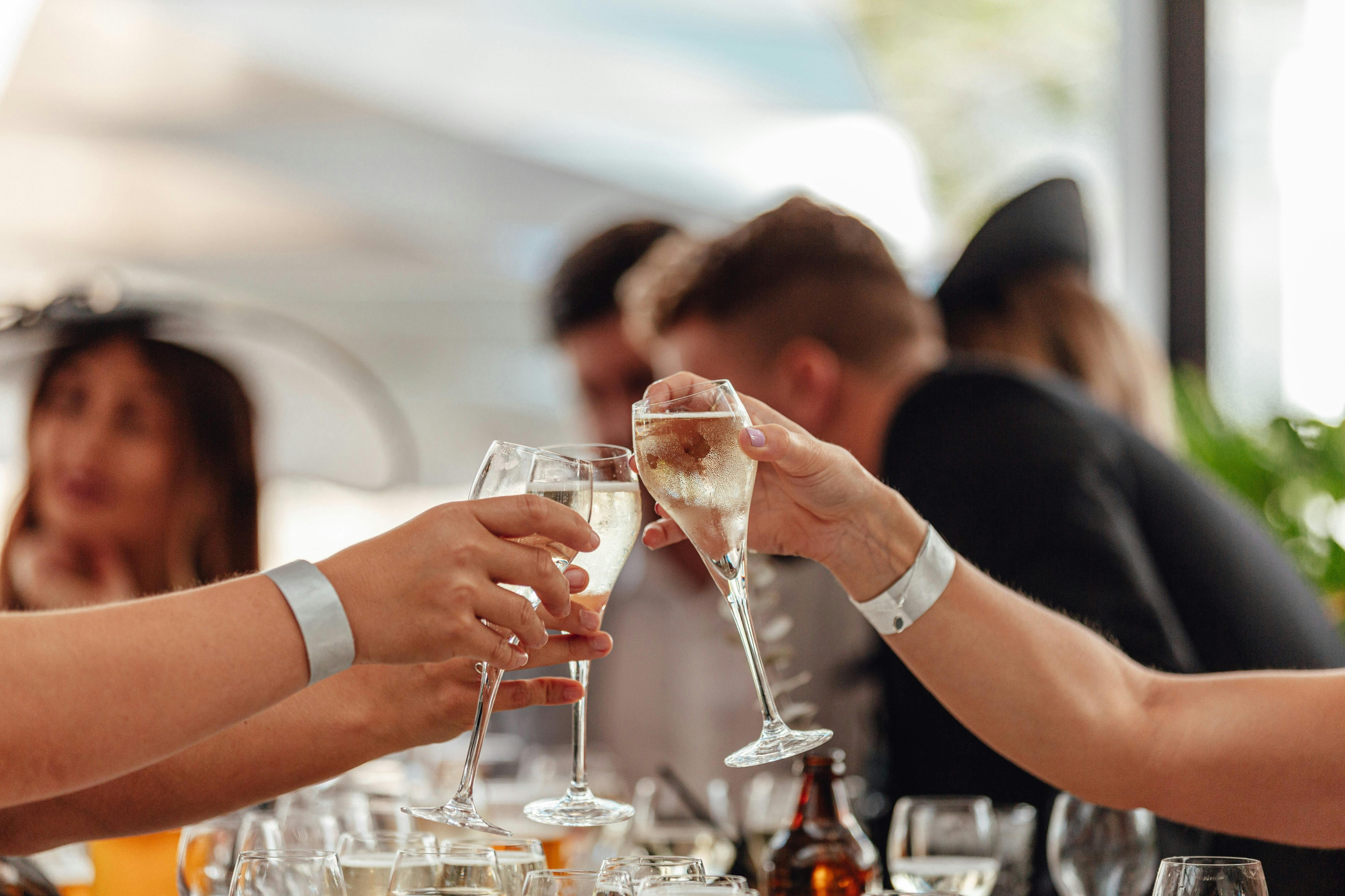 People clinking drinks