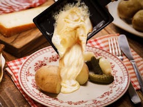 A French Raclette Melted Cheese Igloo Experience