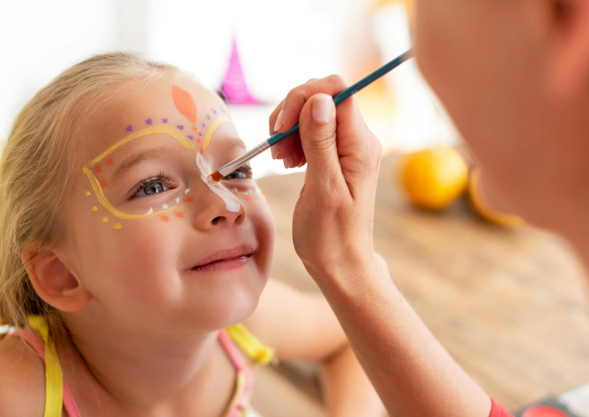 Young girl getting her face painted
