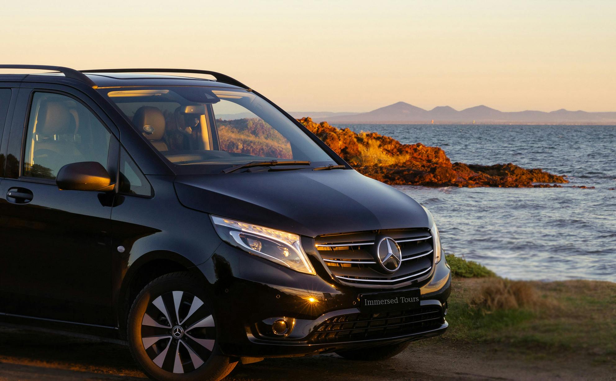 Black Van parked along the coast