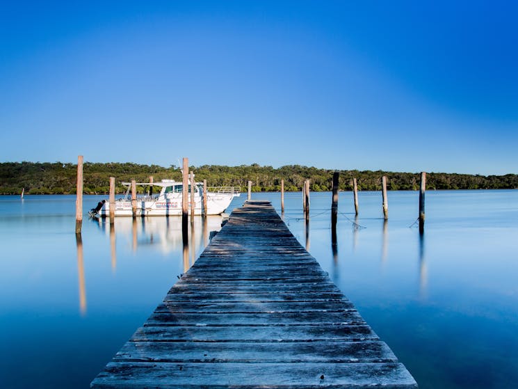 Jetty surrounded by water with boat