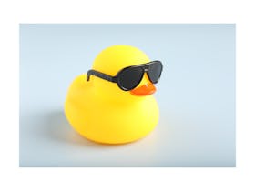 A bright yellow cute rubber duck with dark sunglasses on.