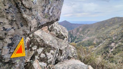 Mindjagari Track marker on rock with mountain view