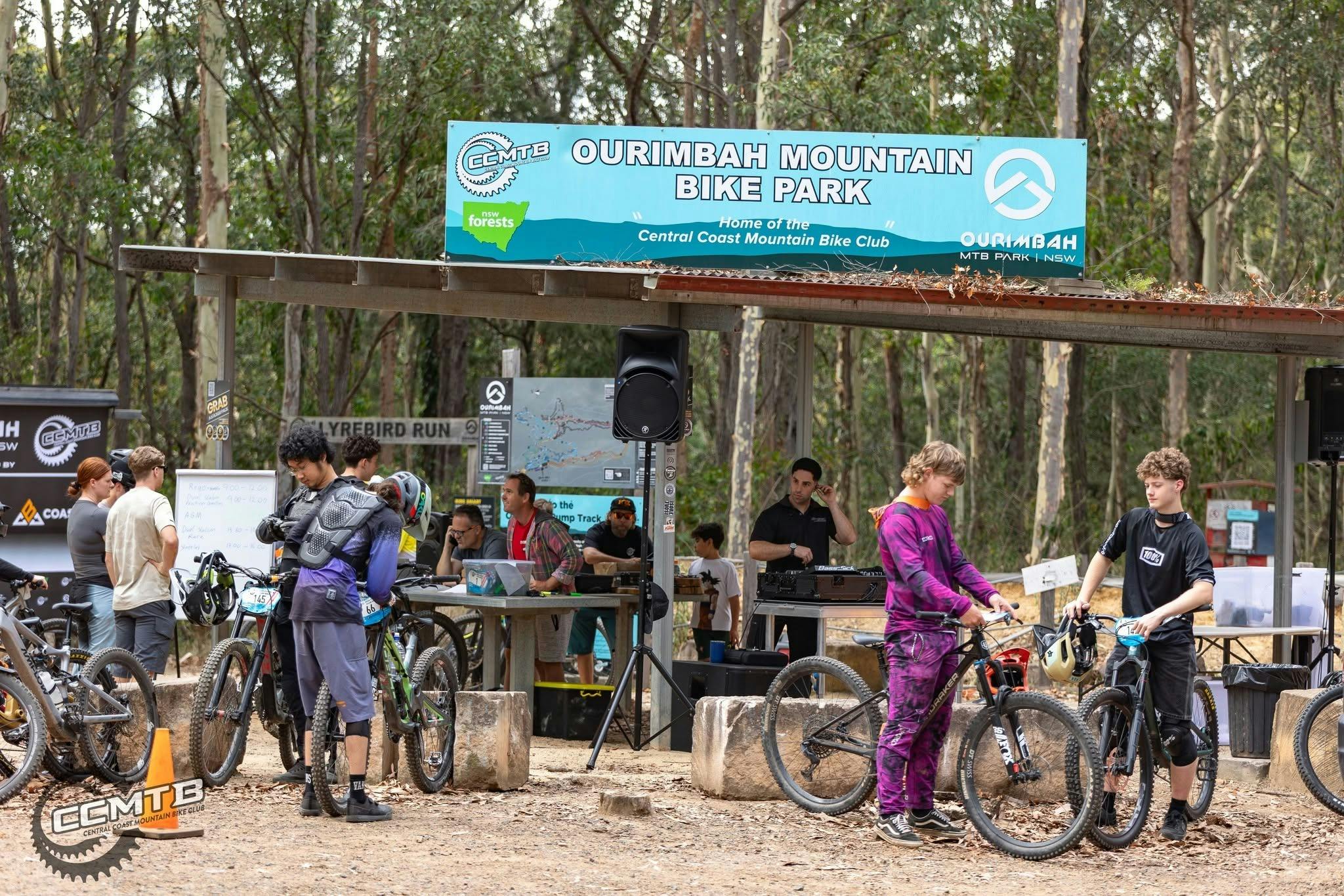 Riders gather with their bikes at the CCMTB end of year party under the Ourimbah Mountain Bike Park