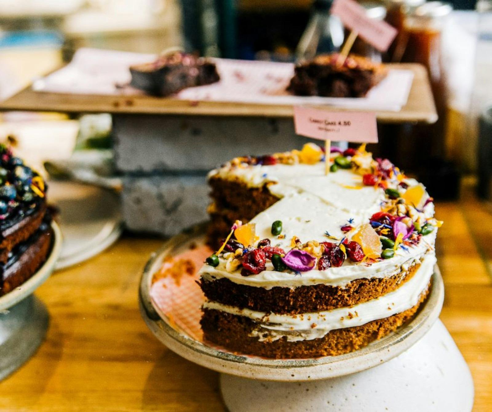 Large cake on a table with other cakes in background