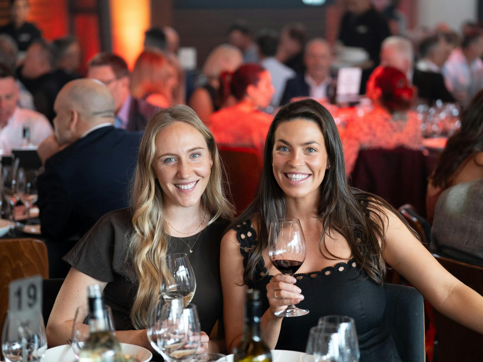 Two guests drinking red wine