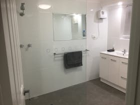 Both bathrooms have toilets and there is a third toilet in the laundry.