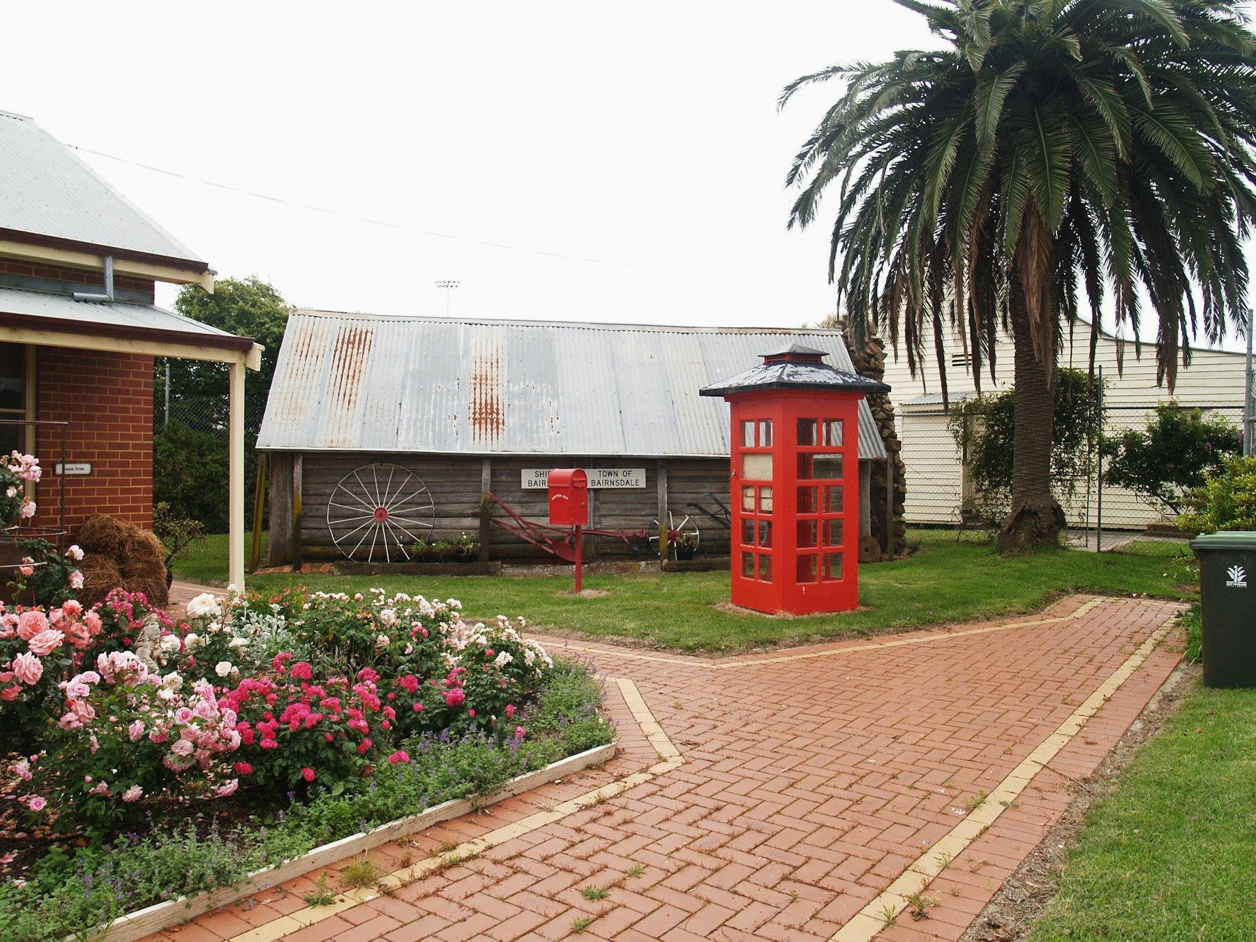 The old red telephone box, old postal stand and 'Calajero' log hut behind