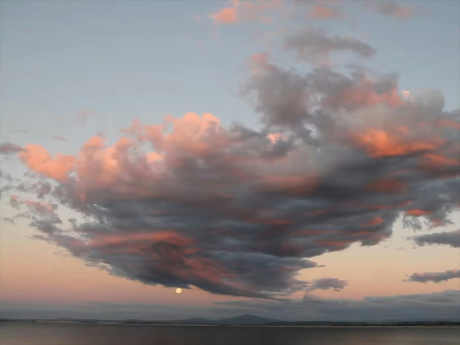 Storm cloud tinged with pink