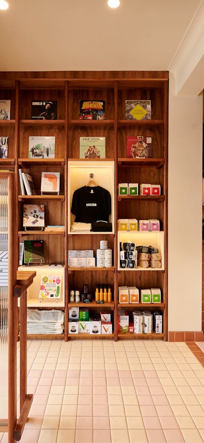 this photo shows a retail display of coffee and books, a front counter of a cafe and some vinyl