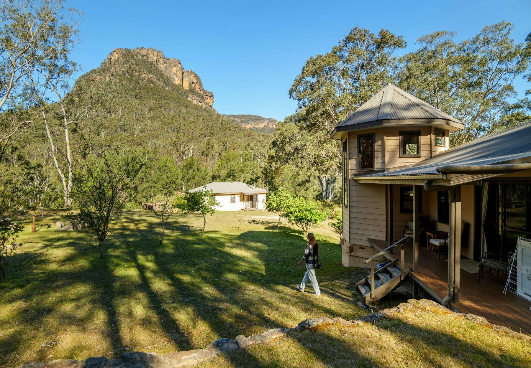 Exterior of one of the Newnes Hotel cabins showing a mountain in the background