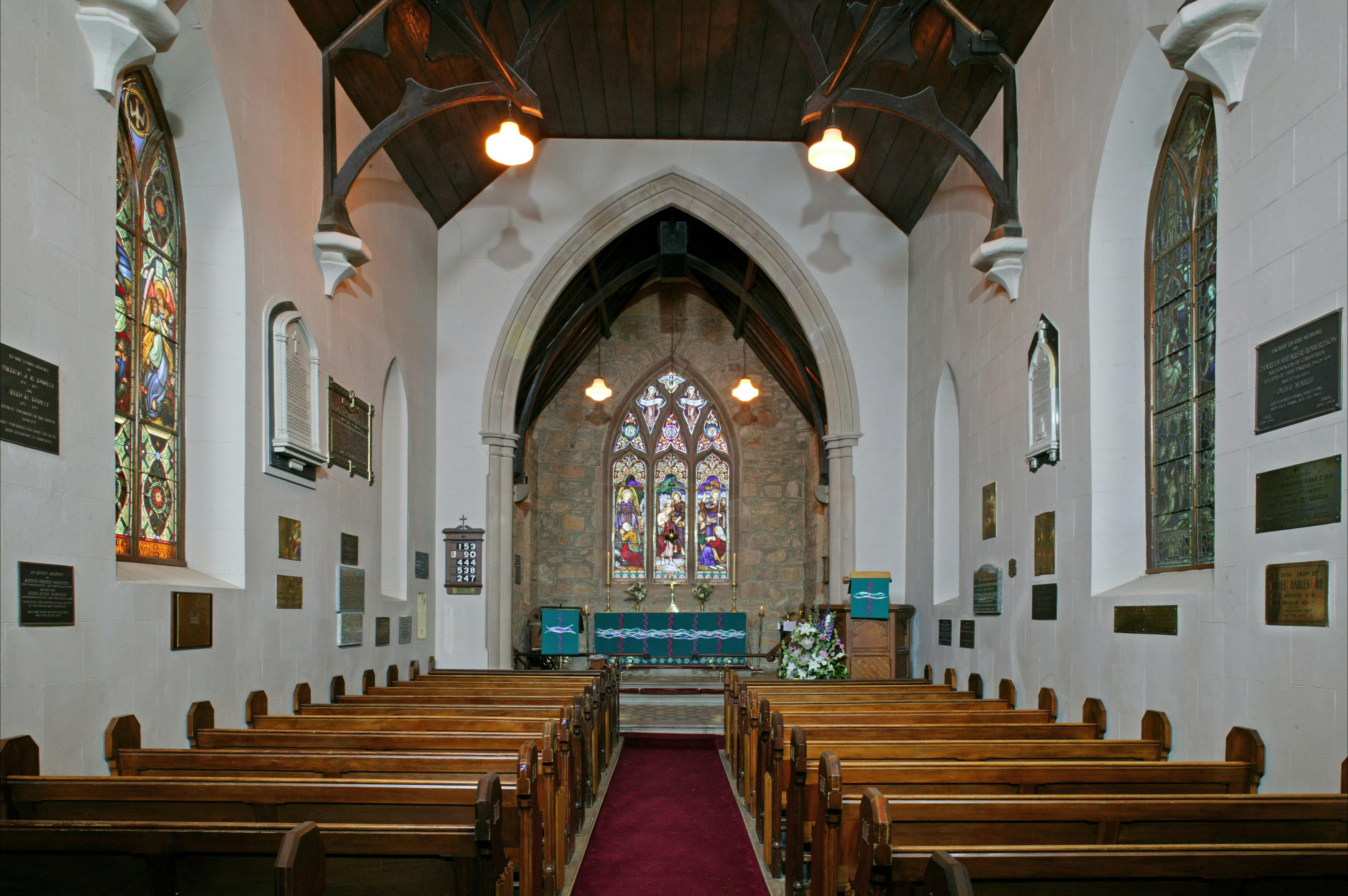 Interior of traditional stone church with stained glass windows