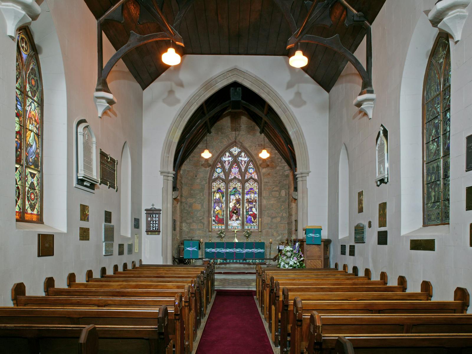Interior of traditional stone church with stained glass windows