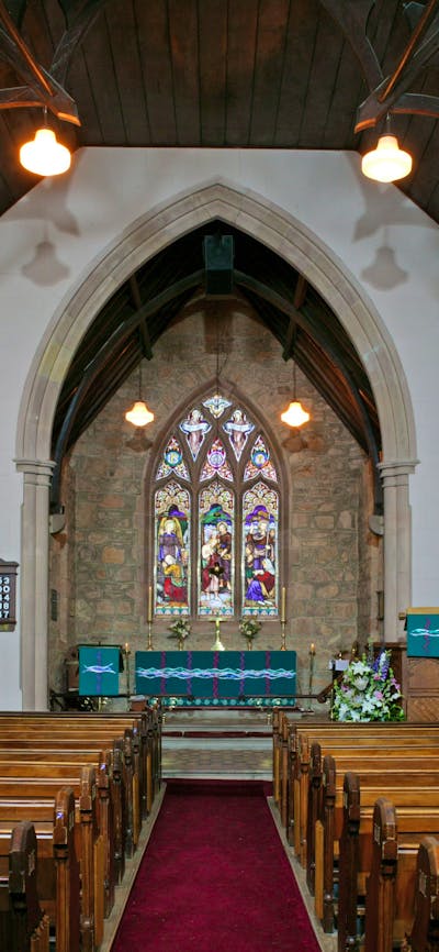 Interior of traditional stone church with stained glass windows