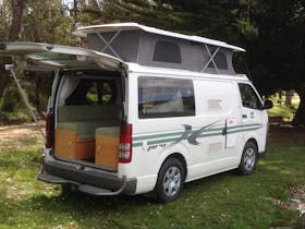 Campervan shown set up for camping.